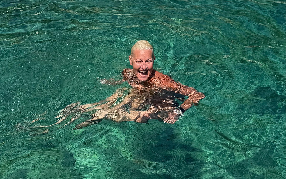Myrto Mangrioti swimming in clear turquoise water