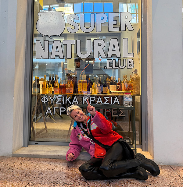 Myrto Mangrioti outside a shop in Athens, pointing upward